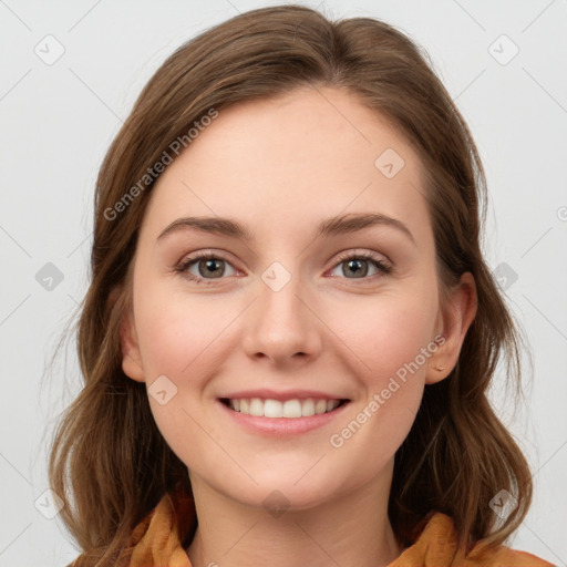 Joyful white young-adult female with long  brown hair and blue eyes