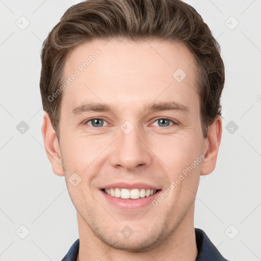 Joyful white young-adult male with short  brown hair and grey eyes