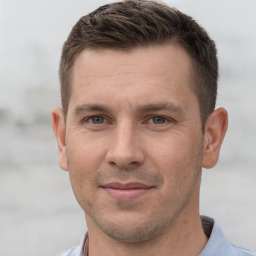 Joyful white adult male with short  brown hair and brown eyes