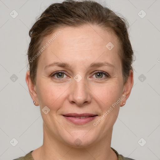 Joyful white adult female with short  brown hair and grey eyes