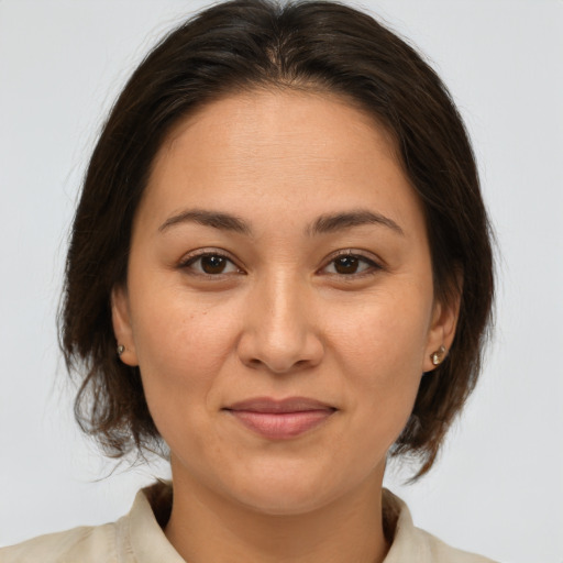 Joyful white adult female with medium  brown hair and brown eyes