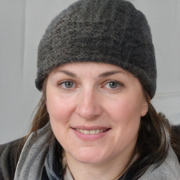 Joyful white young-adult female with medium  brown hair and blue eyes