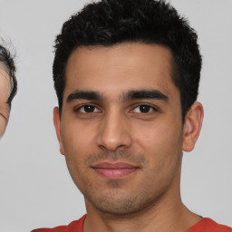 Joyful latino young-adult male with short  black hair and brown eyes