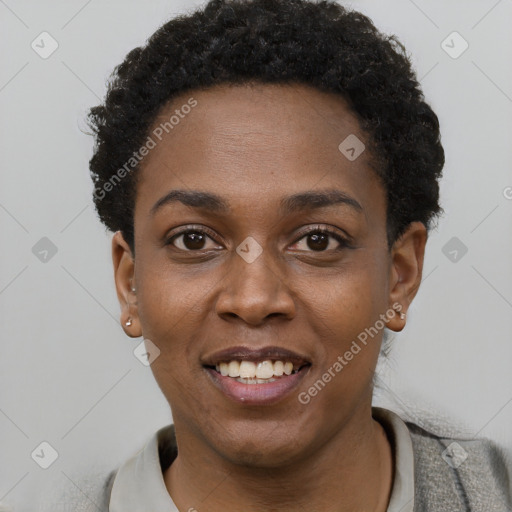 Joyful black young-adult female with short  black hair and brown eyes