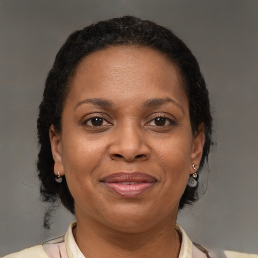 Joyful black adult female with medium  brown hair and brown eyes