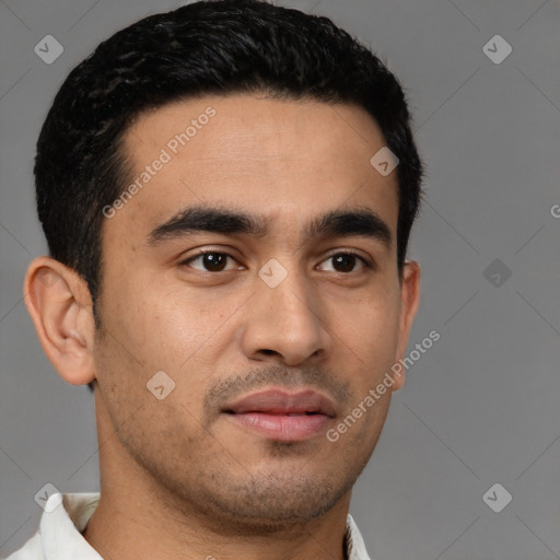 Joyful latino young-adult male with short  brown hair and brown eyes