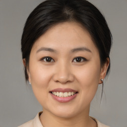 Joyful asian young-adult female with medium  brown hair and brown eyes