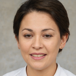 Joyful white adult female with medium  brown hair and brown eyes