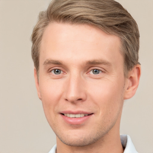 Joyful white adult male with short  brown hair and grey eyes