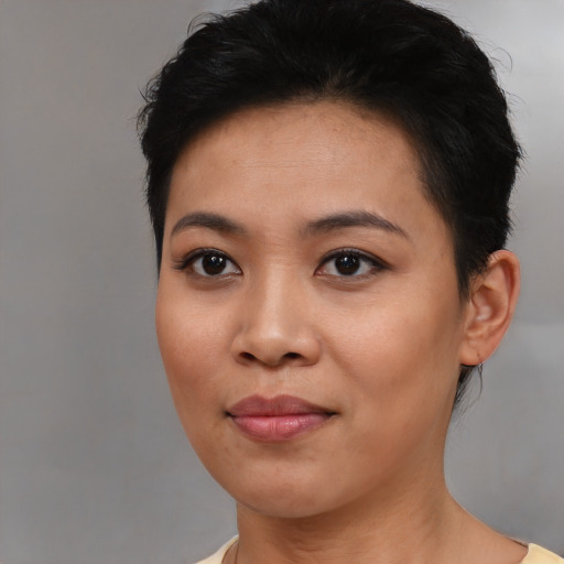 Joyful asian young-adult female with short  black hair and brown eyes