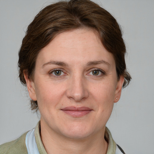 Joyful white adult female with short  brown hair and grey eyes