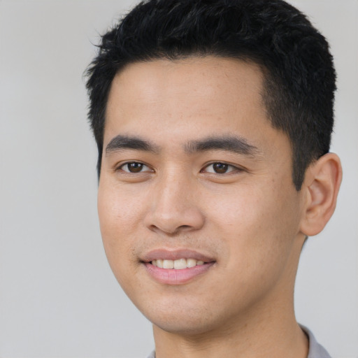 Joyful asian young-adult male with short  black hair and brown eyes