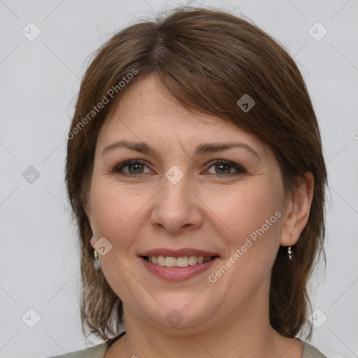 Joyful white adult female with medium  brown hair and grey eyes