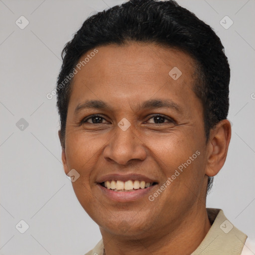 Joyful latino adult male with short  black hair and brown eyes
