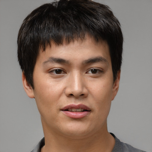 Joyful asian young-adult male with short  brown hair and brown eyes