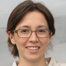 Joyful white adult female with medium  brown hair and brown eyes