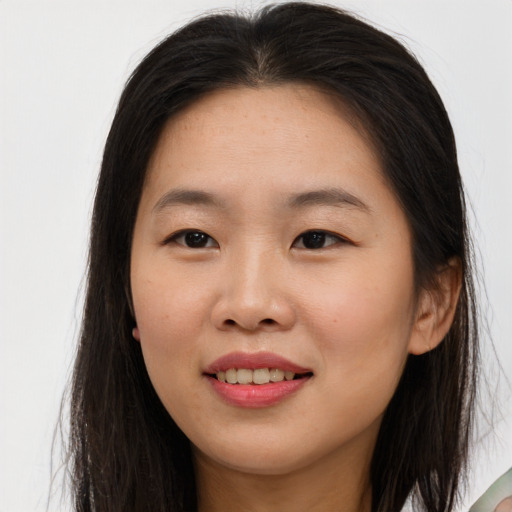 Joyful asian young-adult female with long  brown hair and brown eyes