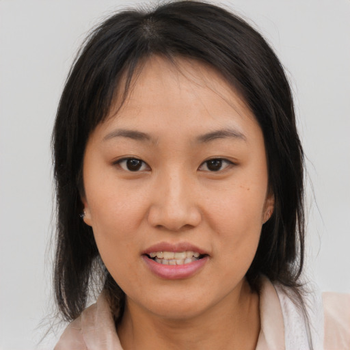 Joyful asian young-adult female with medium  brown hair and brown eyes