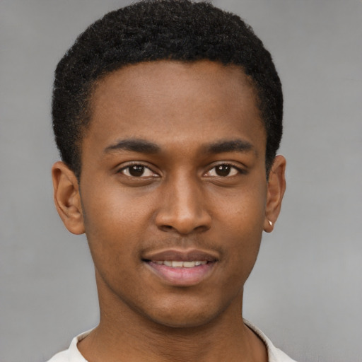 Joyful black young-adult male with short  brown hair and brown eyes