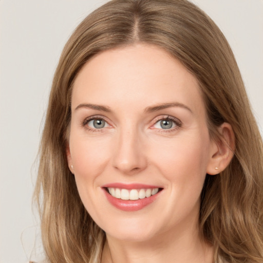 Joyful white young-adult female with long  brown hair and blue eyes