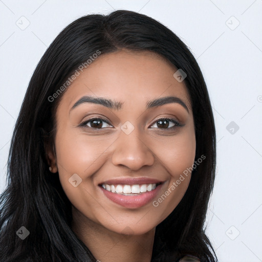 Joyful latino young-adult female with long  black hair and brown eyes