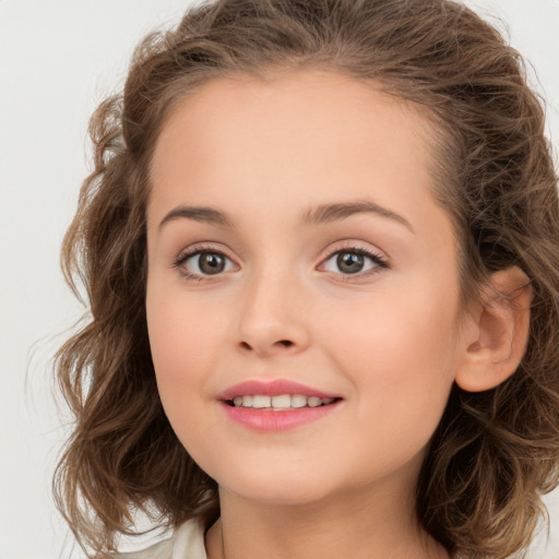 Joyful white child female with medium  brown hair and brown eyes