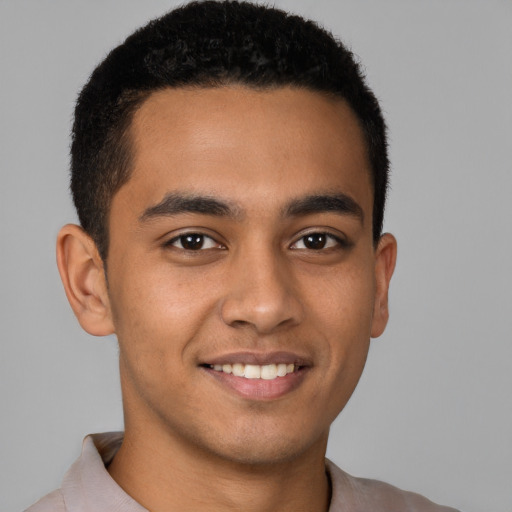 Joyful latino young-adult male with short  brown hair and brown eyes