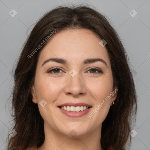 Joyful white young-adult female with long  brown hair and brown eyes