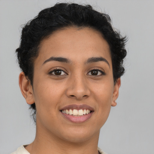 Joyful latino young-adult female with short  brown hair and brown eyes