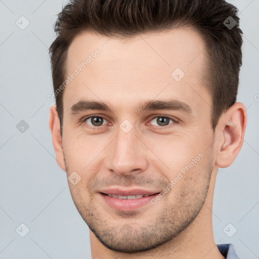 Joyful white young-adult male with short  brown hair and brown eyes