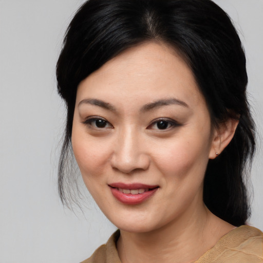 Joyful asian young-adult female with medium  black hair and brown eyes