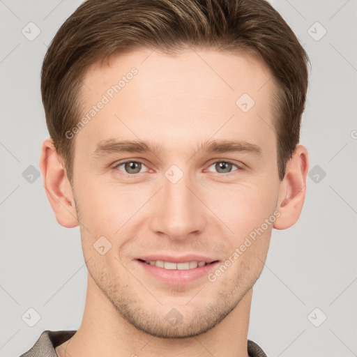 Joyful white young-adult male with short  brown hair and grey eyes