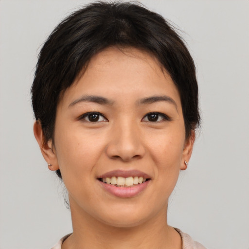 Joyful asian young-adult female with short  brown hair and brown eyes