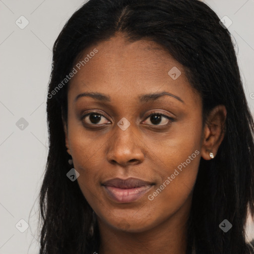 Joyful black young-adult female with long  brown hair and brown eyes