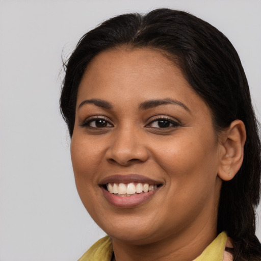 Joyful latino young-adult female with medium  brown hair and brown eyes