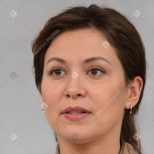 Joyful white adult female with medium  brown hair and brown eyes