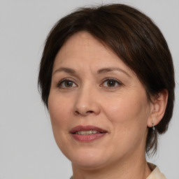 Joyful white adult female with medium  brown hair and brown eyes