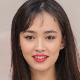 Joyful asian young-adult female with long  brown hair and brown eyes