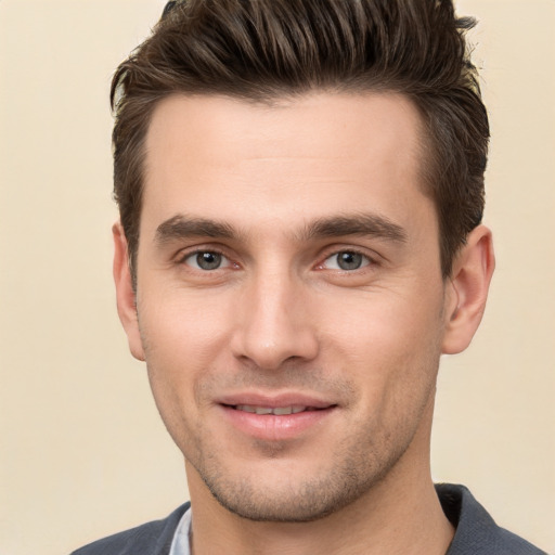 Joyful white young-adult male with short  brown hair and brown eyes