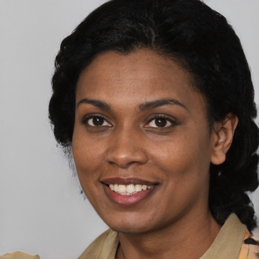 Joyful black young-adult female with medium  black hair and brown eyes