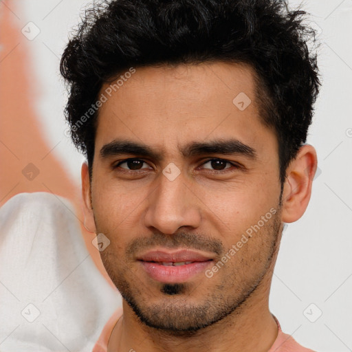 Joyful latino young-adult male with short  brown hair and brown eyes