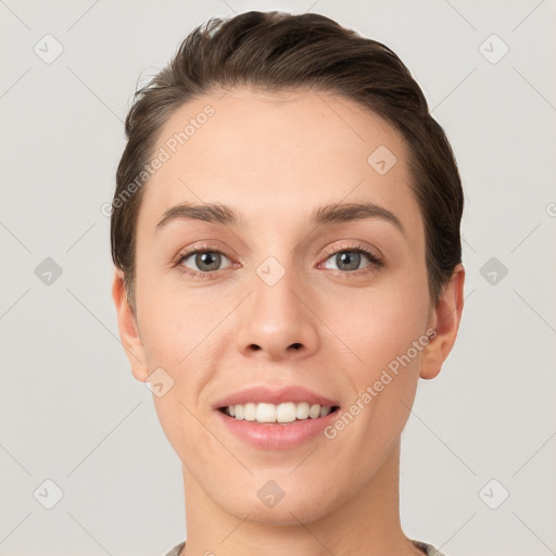 Joyful white young-adult female with short  brown hair and grey eyes