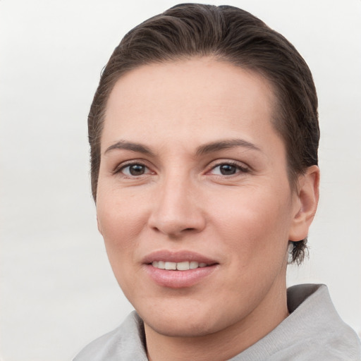 Joyful white young-adult female with short  brown hair and grey eyes