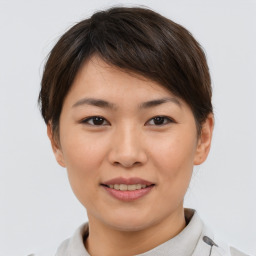 Joyful asian young-adult female with short  brown hair and brown eyes