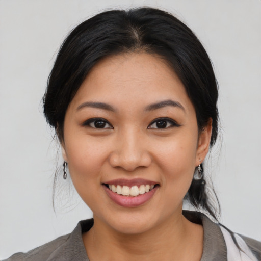 Joyful asian young-adult female with medium  black hair and brown eyes