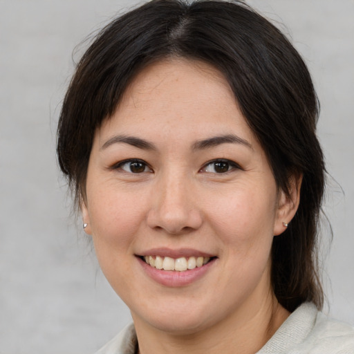 Joyful white young-adult female with medium  brown hair and brown eyes