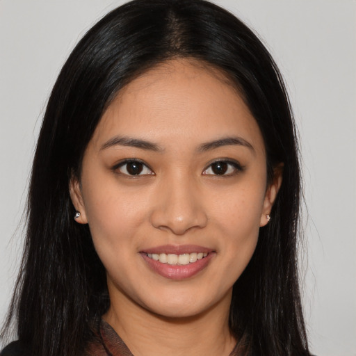 Joyful latino young-adult female with long  brown hair and brown eyes