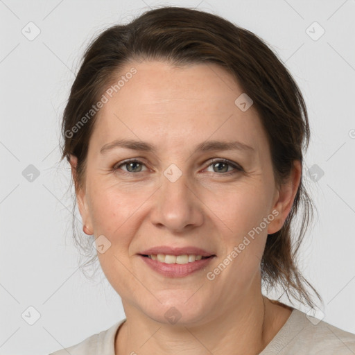 Joyful white adult female with medium  brown hair and grey eyes