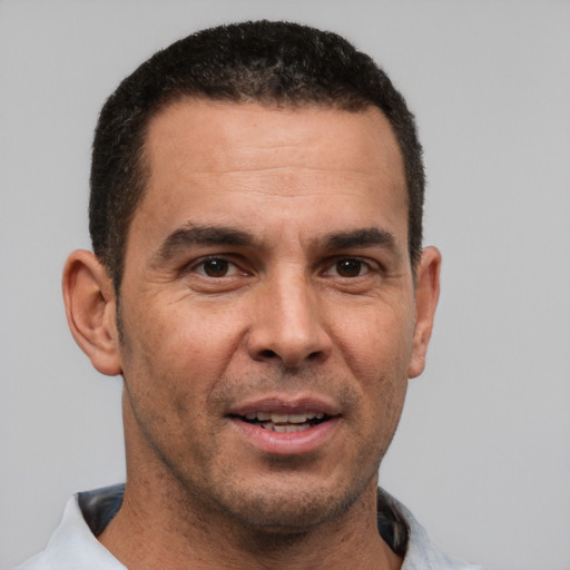 Joyful white adult male with short  brown hair and brown eyes