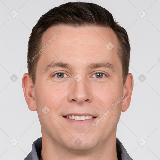 Joyful white young-adult male with short  brown hair and grey eyes